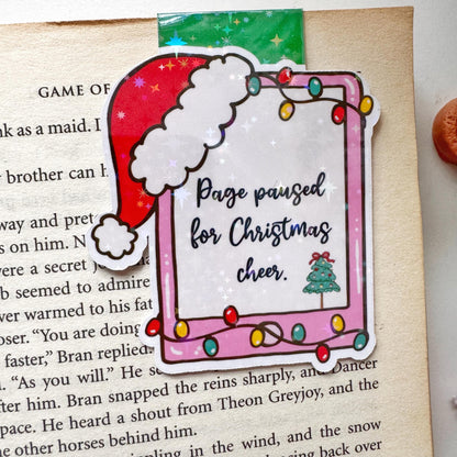 Page paused for Christmas Cheer Santa Cap Magnetic Bookmark: Book Lover Gift